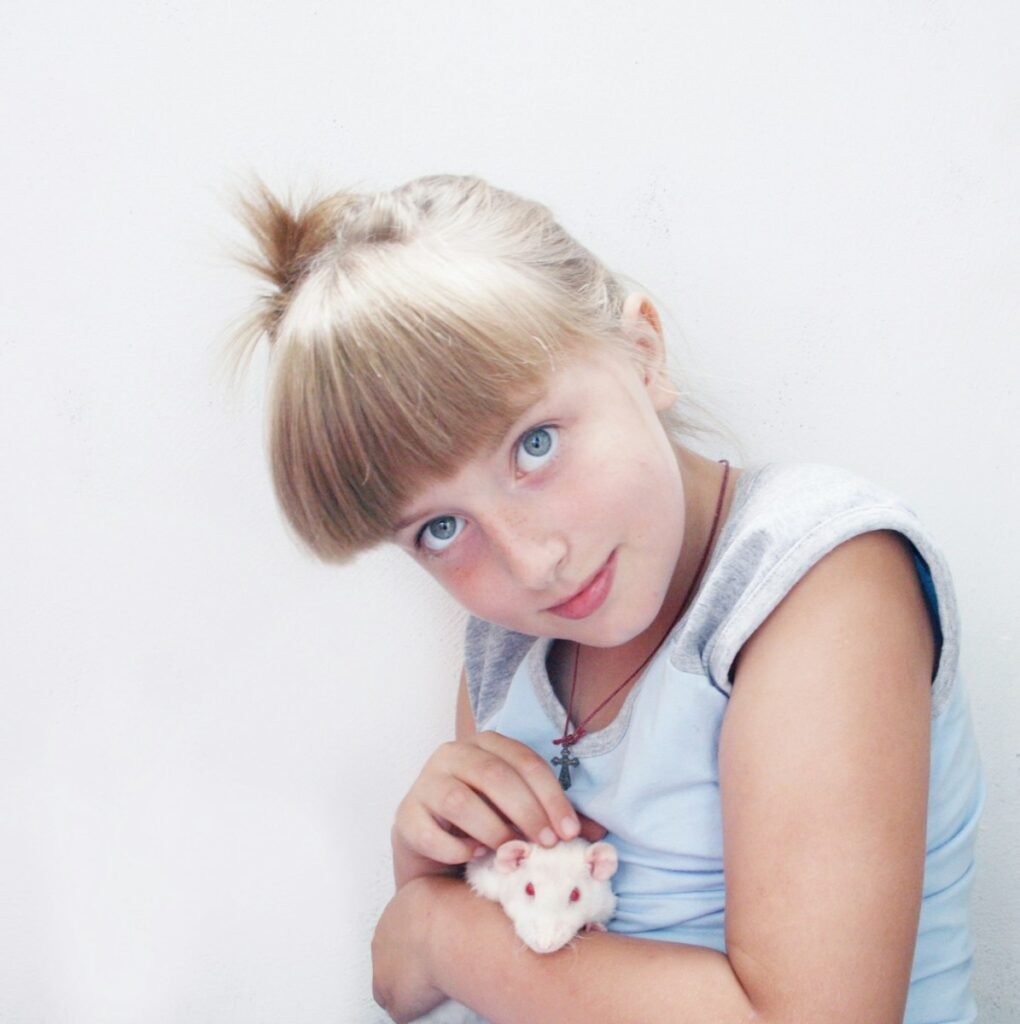a young girl holding a stuffed animal in her hands